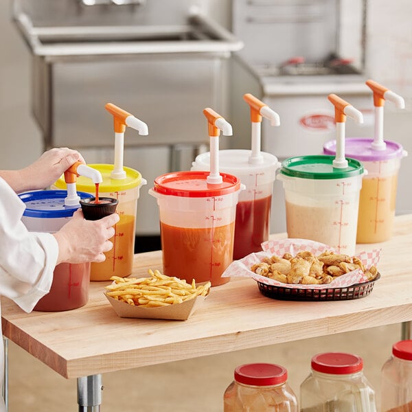 A woman using a Choice translucent container with a Maxi pump to pour liquid into plastic cups on a counter.