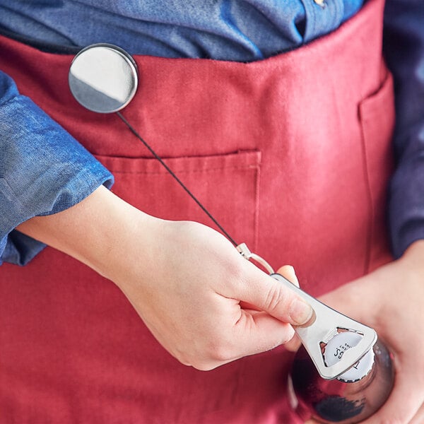 a person holding a bottle opener