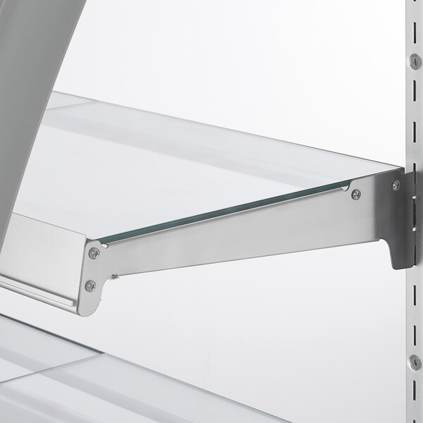 A glass shelf with metal supports inside a refrigerated bakery display case.