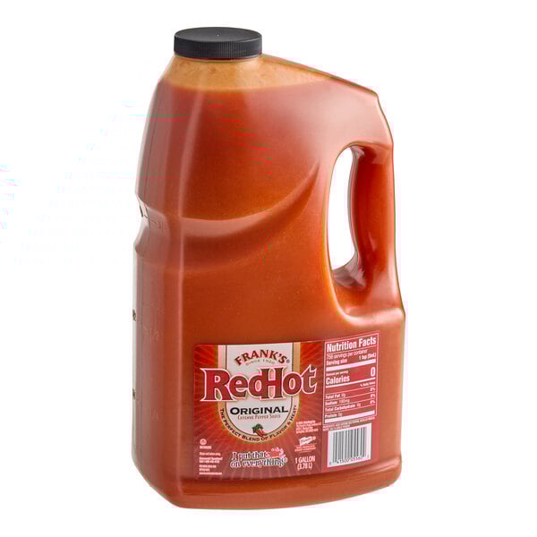 A 1-gallon jug of Frank's RedHot Original Hot Sauce with a handle and black cap.