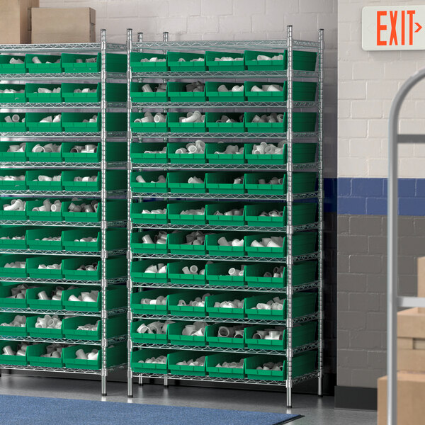 A Regency wire shelving unit with green bins on it.