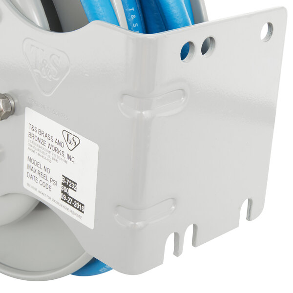 A T&S blue and white steel hose reel with a blue hose attached to it.