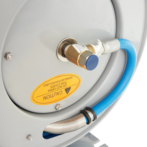 An open T&S hose reel with a blue hose attached to a pipe.