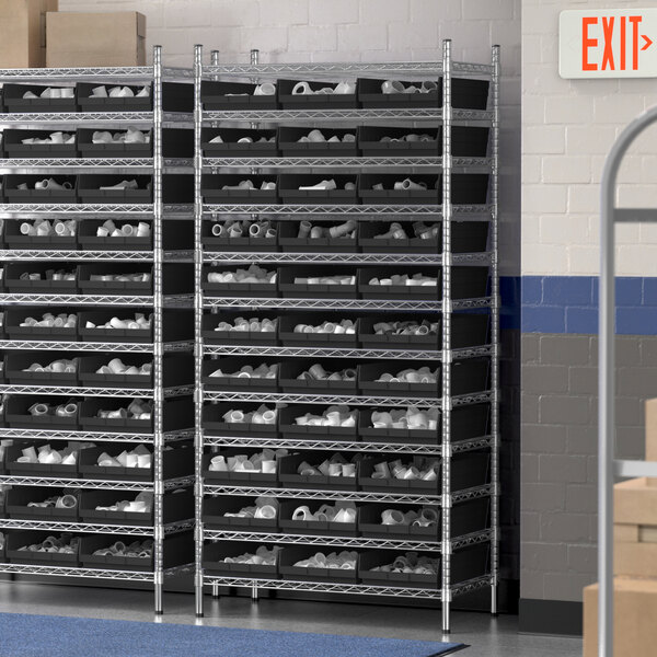 A Regency wire shelving unit with black bins holding shoes.