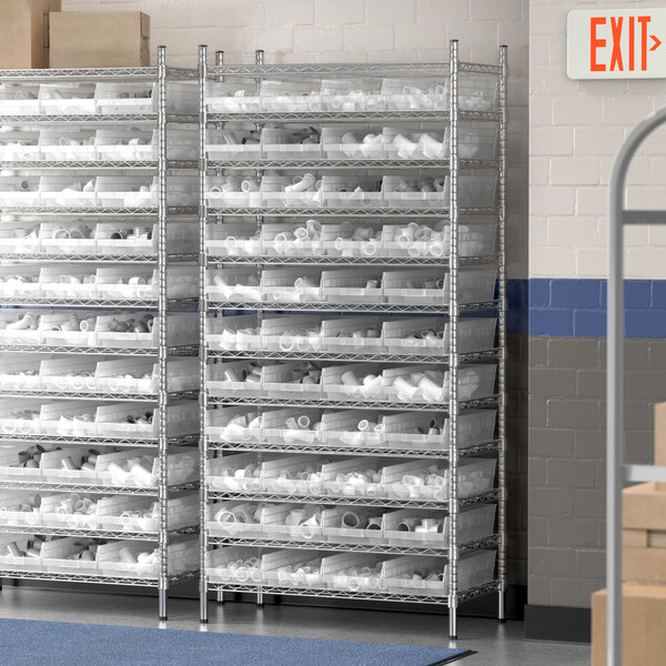 A Regency metal wire shelving unit with clear plastic bins on the shelves.