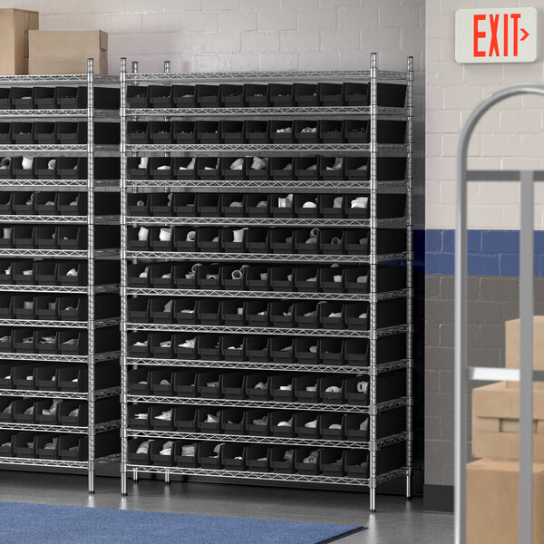 A Regency wire shelving unit with black bins on shelves.