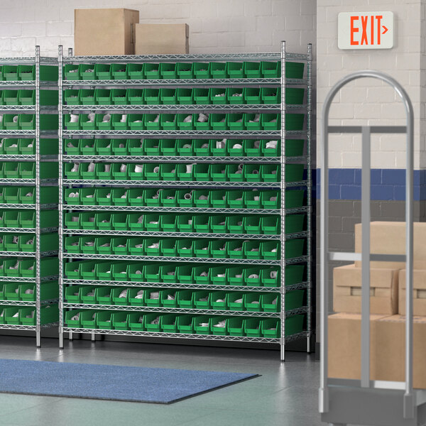 A Regency wire shelving unit with green bins on each shelf.