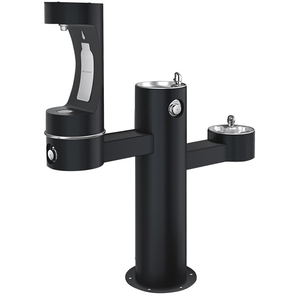 An Elkay black outdoor tri-level drinking fountain with two faucets and a middle pedestal bottle filling station.
