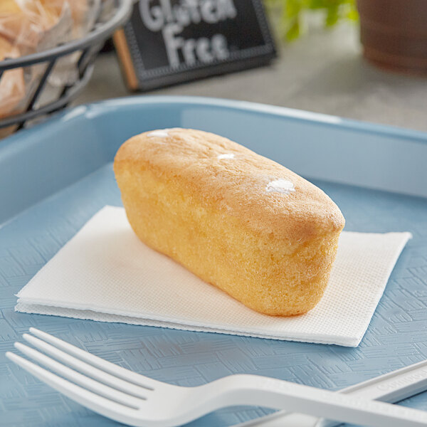 An individually wrapped Katz Gluten-Free Heavenly Vanilla Creme Cake on a blue plate.