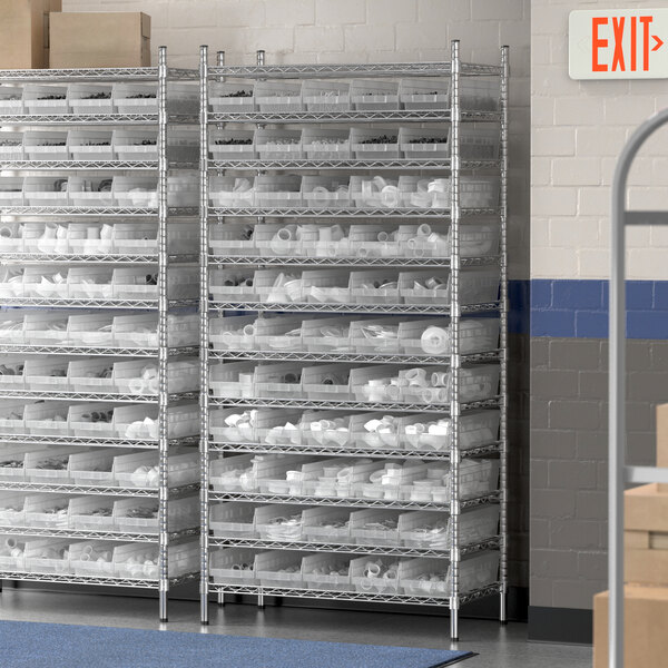 A Regency metal wire shelving unit with clear plastic bins on the shelves.