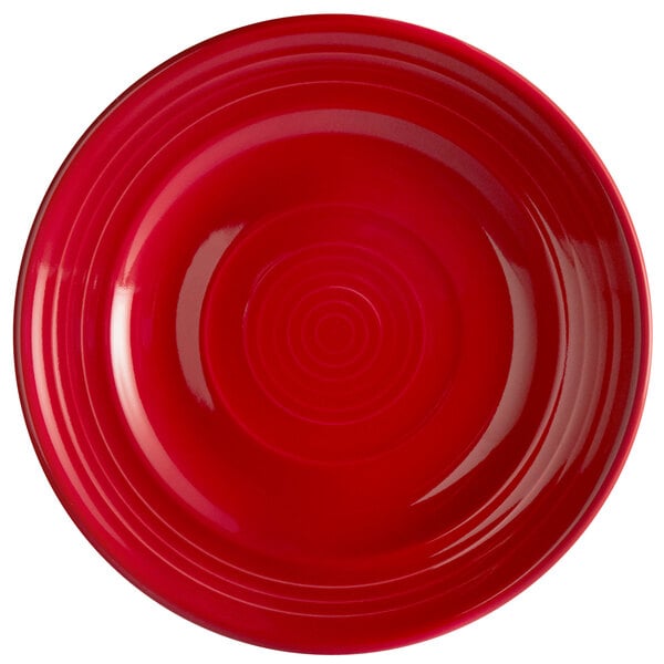 A red Tuxton Concentrix China plate with a circular spiral pattern.
