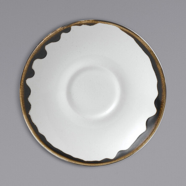 A close up of a white Dudson Harvest espresso saucer with black trim.