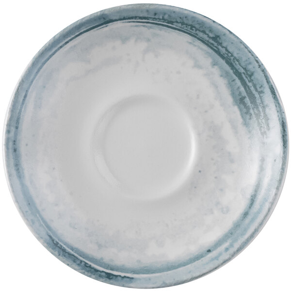 A close-up of a Dudson Maker's Finca limestone saucer with a small hole in the middle.
