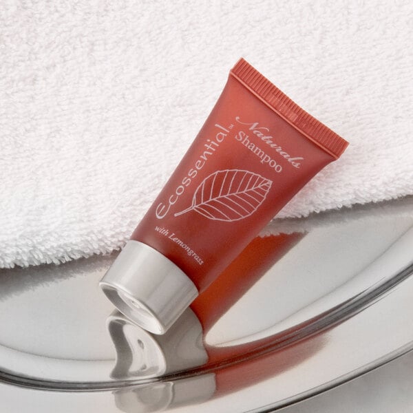 A small Ecossential Naturals shampoo bottle on a silver tray.