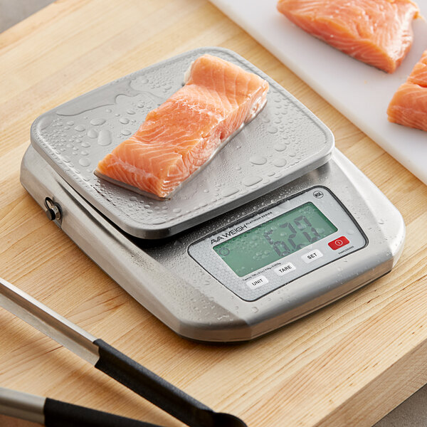 An AvaWeigh stainless steel digital portion scale weighing a piece of salmon.