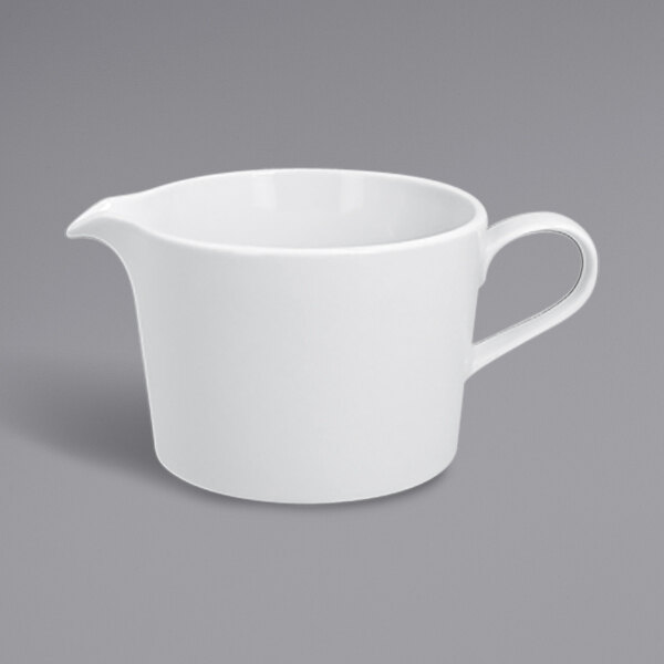 A white RAK Porcelain gravy boat with a handle.