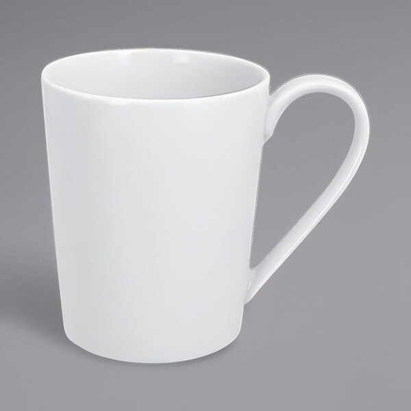 A close-up of a RAK Porcelain white mug with a white handle.