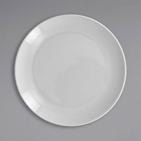 A close-up of a RAK Porcelain white flat coupe plate.