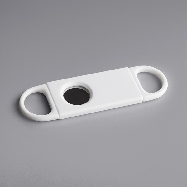 A white rectangular Franmara cigar cutter with a black circle.