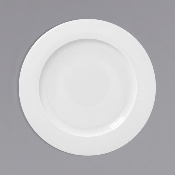 A white plate with a wide rim on a white background.