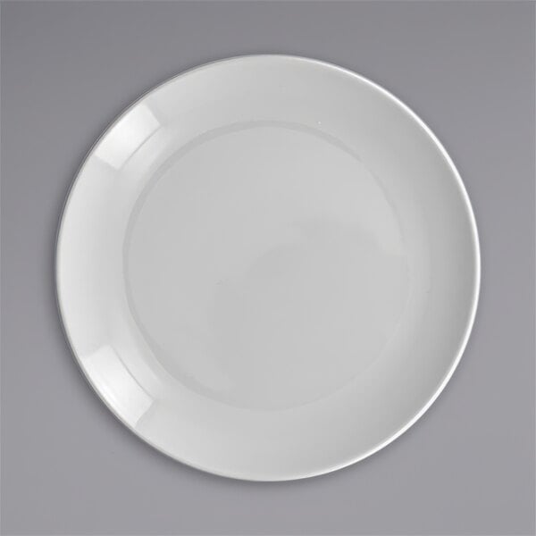 A close-up of a white RAK Porcelain flat coupe plate.