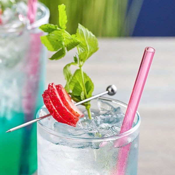 A red Franmara reusable straw in a drink with strawberries on a skewer.