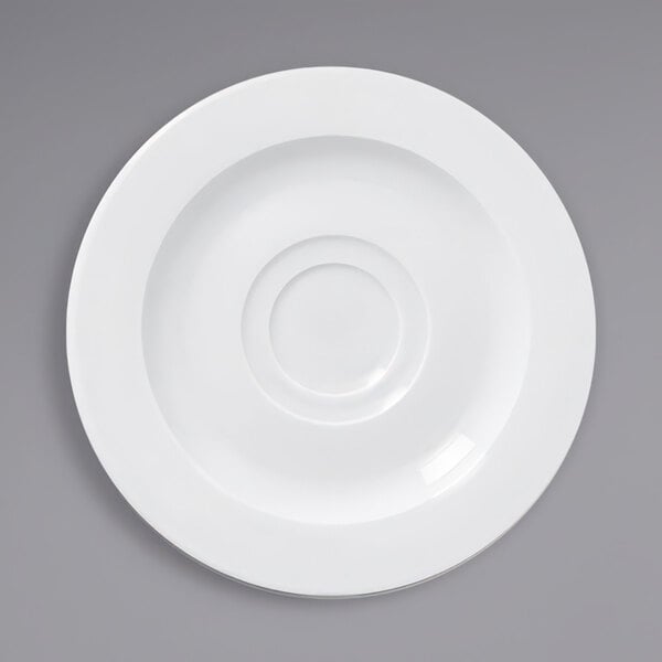 A white porcelain saucer with a circular rim and a circle in the middle.