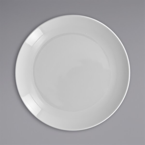 A close up of a white RAK Porcelain flat coupe plate with a circle in the middle.