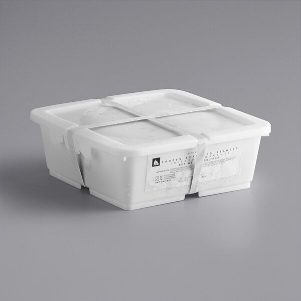 A white plastic container of Goma Wakame Seaweed Salad with a white label.