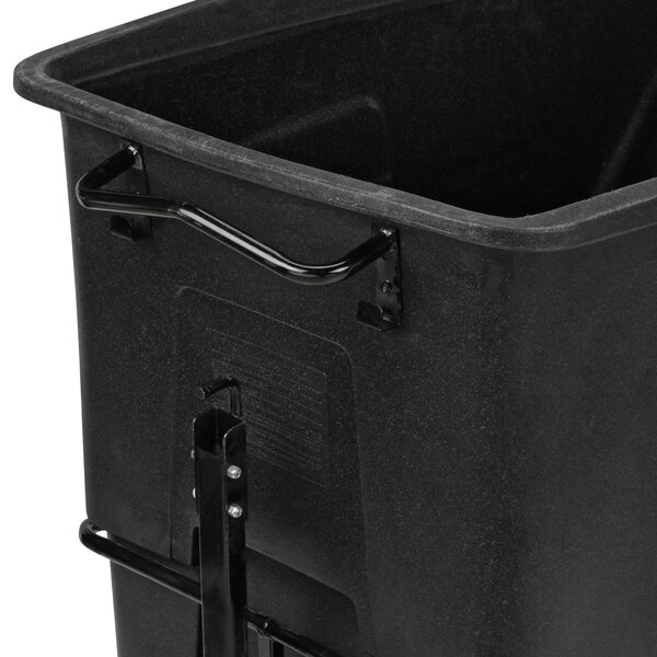 A black Toter towable tilt truck with a handle.