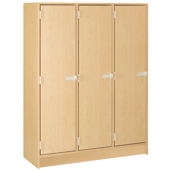 A wooden locker with three doors.