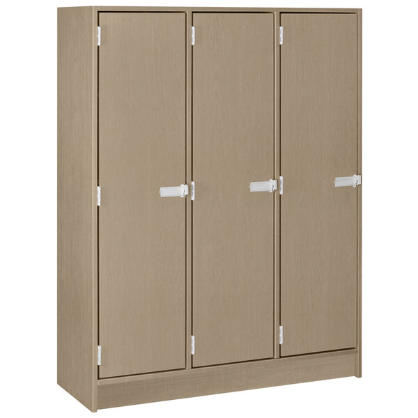 A brown locker with white handles with three doors.