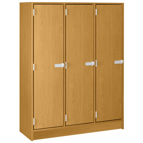 A light oak wooden locker with three doors and white handles.
