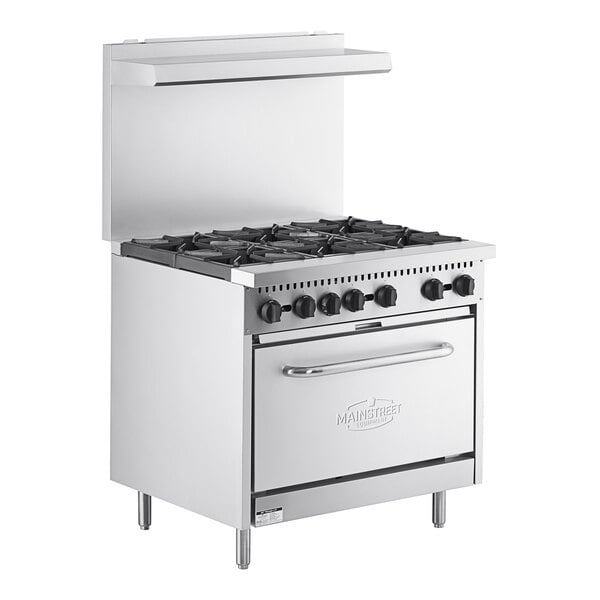 A stainless steel MainStreet Equipment range with 6 burners and an open oven door.
