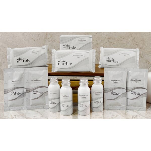 A white box with black text reading "Dial Breck Conditioning Shampoo" next to white packages and bottles with black and silver text.