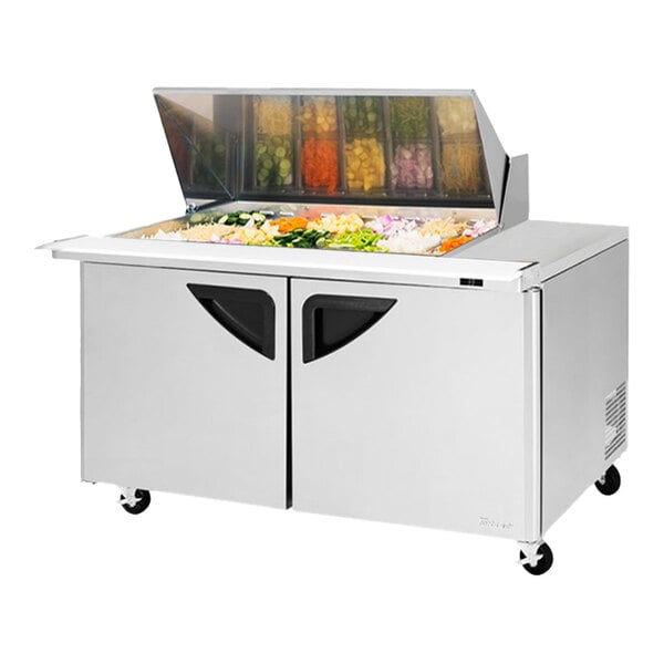 A Turbo Air 2 door mega top sandwich prep table with food on top.