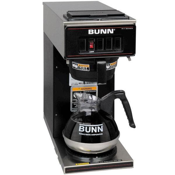 A Bunn black pourover coffee maker on a counter with a glass pitcher.
