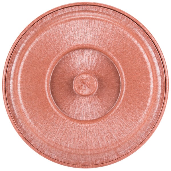 A close-up of a pink circular tortilla server lid.