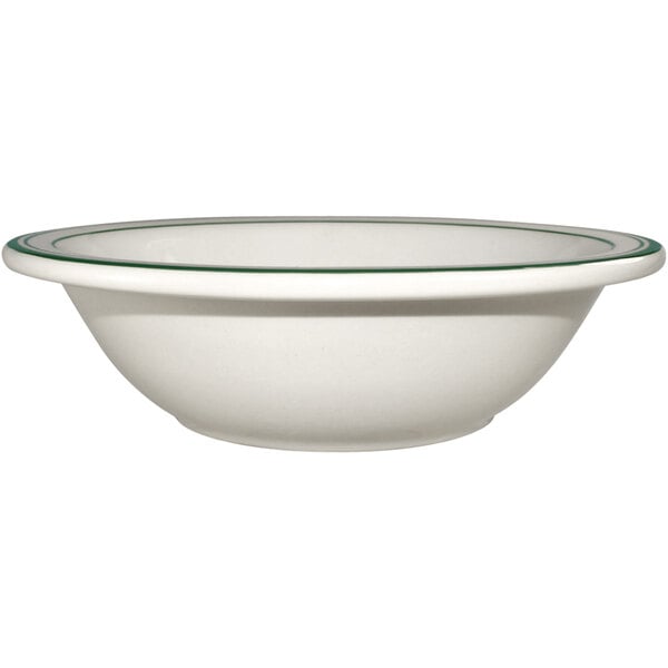 a white bowl with a green rim