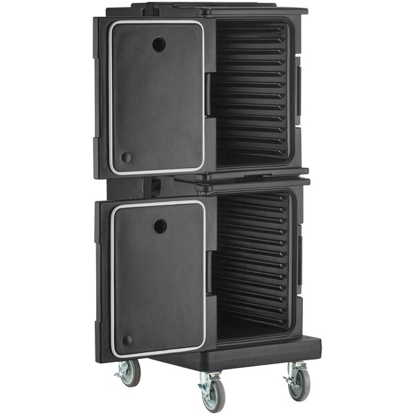 A black plastic front loading food pan carrier with a white strap and wheels.