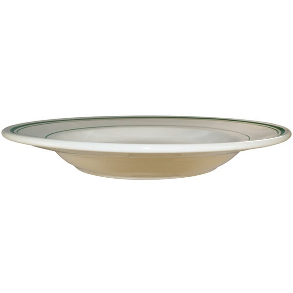 A close-up of an International Tableware Verona stoneware pasta bowl with green bands on the rim.