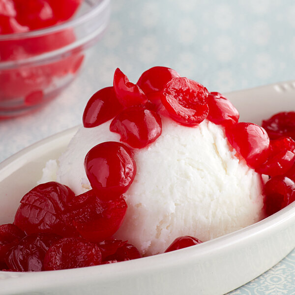 A bowl of ice cream with Regal Maraschino Cherry halves on top.