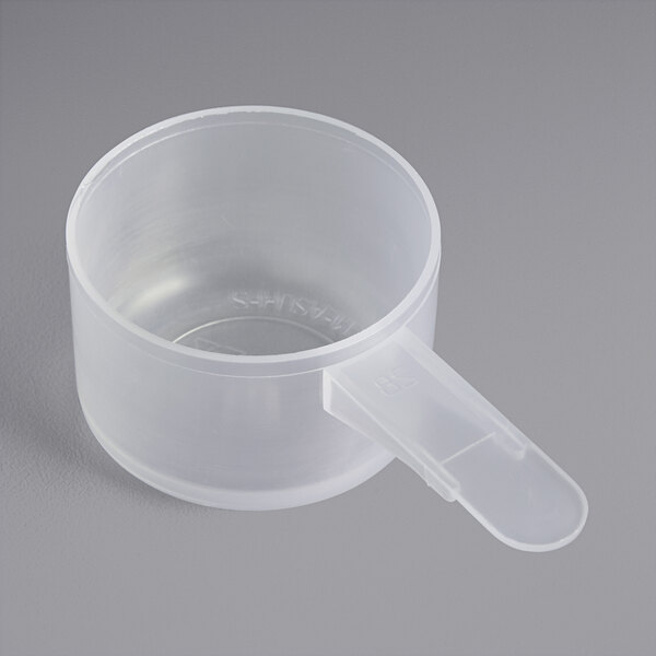 A clear plastic scoop with a handle.