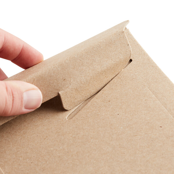 a person opening a brown envelope