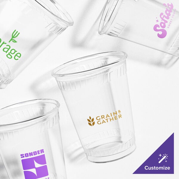 A group of clear Fabri-Kal Greenware plastic cups with logos on them.
