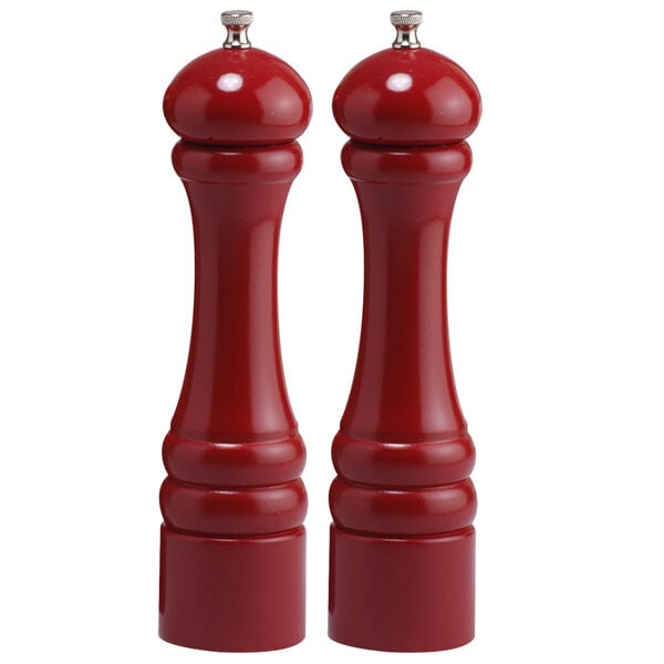 Two Chef Specialties red pepper mills with white tops.