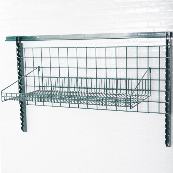 A Metroseal 3 wire grid shelf with retaining ledge on a wall.