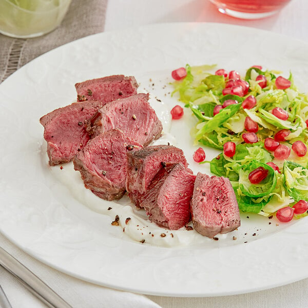 A plate of meat and vegetables, including a Shaffer Venison Farms boneless venison loin steak.