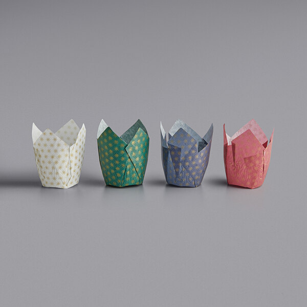 Three Enjay tulip baking cups with star print designs in green, yellow, and white.