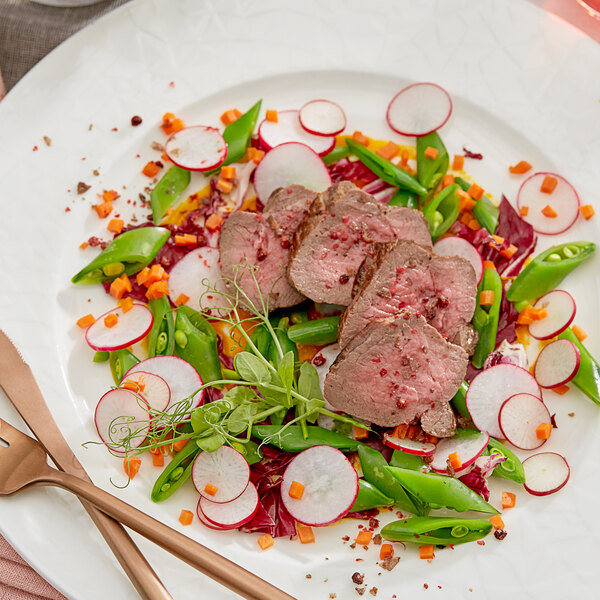 A plate with Shaffer Venison Farms boneless leg medallion steak and vegetables.